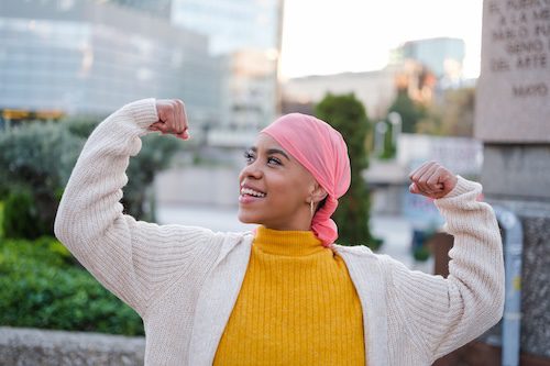 Woman showing strength during holistic cancer support treatment in Charlottesville.